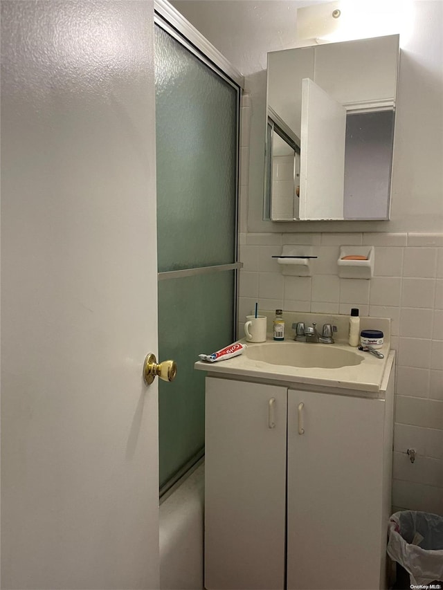 bathroom featuring vanity and tile walls