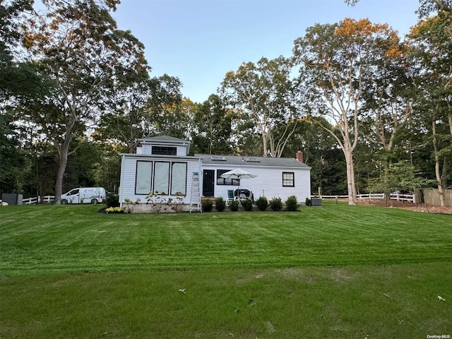 view of outbuilding with cooling unit and a yard