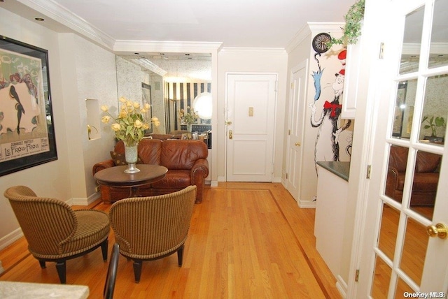 interior space featuring light wood-type flooring and ornamental molding