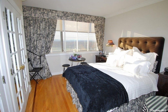 bedroom featuring crown molding and hardwood / wood-style flooring