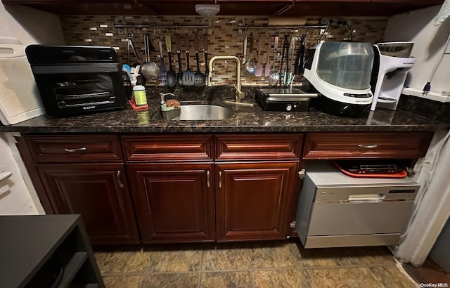 bar featuring tasteful backsplash, sink, and dark stone counters