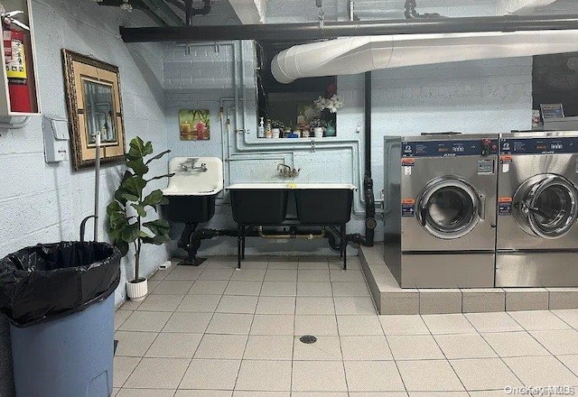 clothes washing area featuring separate washer and dryer and sink