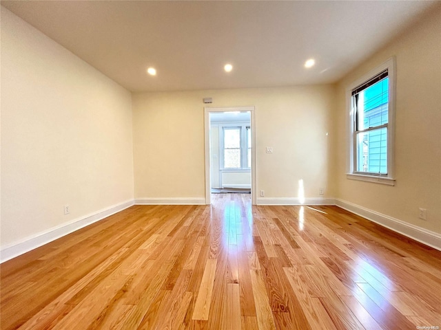 spare room with light hardwood / wood-style flooring and plenty of natural light