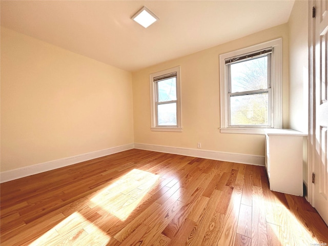 empty room with light hardwood / wood-style floors