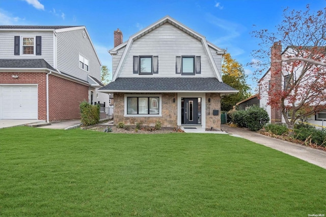 view of front facade with a front yard and a garage