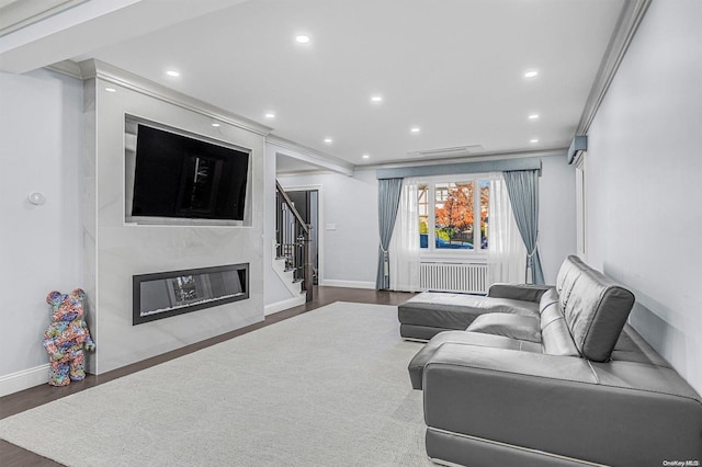 living room featuring radiator, crown molding, and dark hardwood / wood-style floors