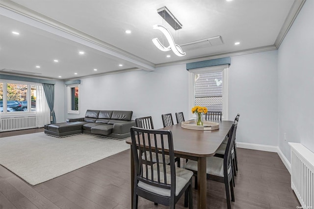 dining space featuring a notable chandelier, crown molding, radiator heating unit, and dark wood-type flooring