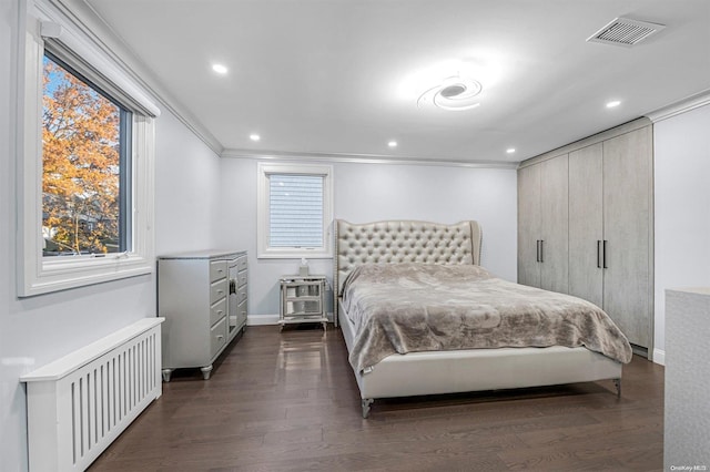 bedroom featuring radiator heating unit, dark wood-type flooring, and ornamental molding