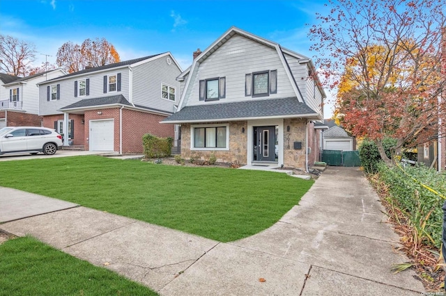 view of front of house featuring a garage and a front lawn