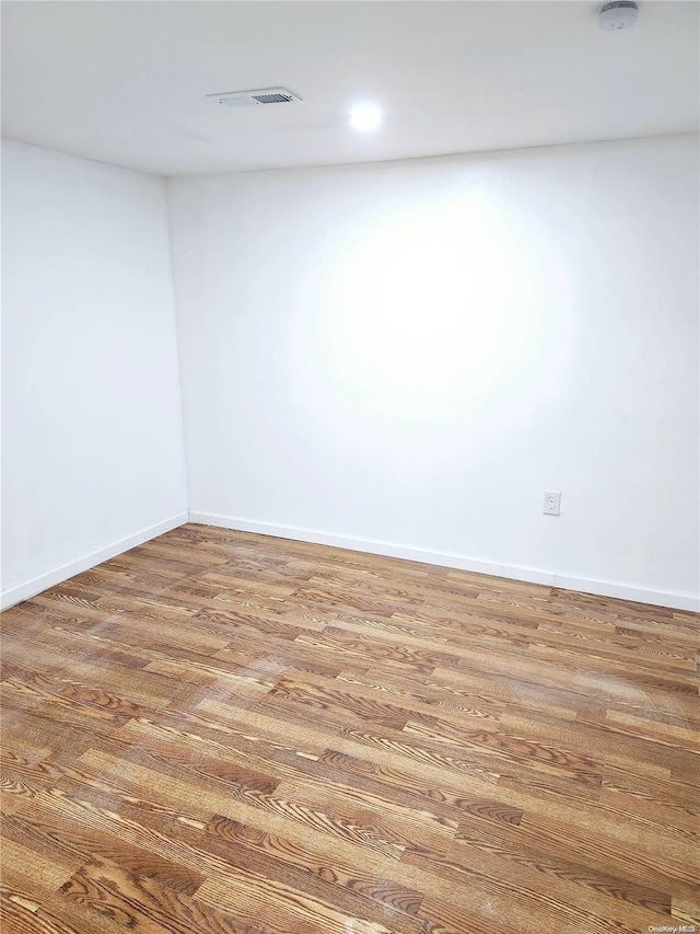 empty room with hardwood / wood-style floors