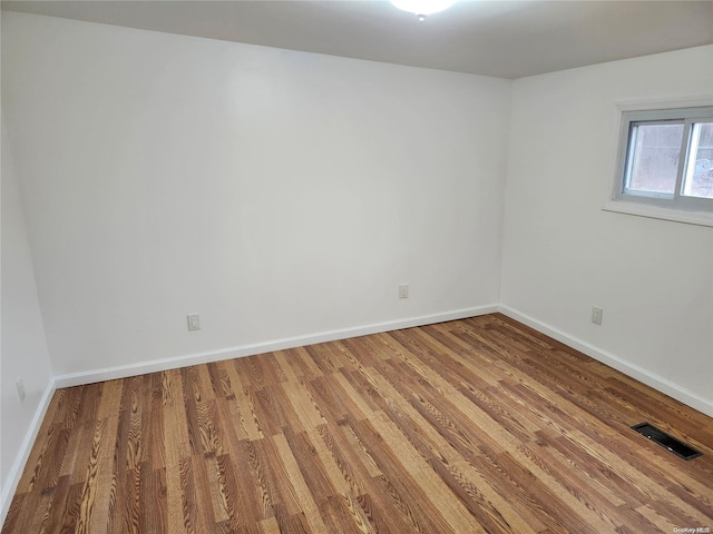 unfurnished room with hardwood / wood-style floors