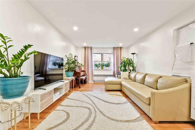 living room featuring light wood-type flooring and radiator heating unit