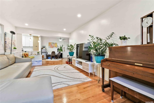 living room featuring ceiling fan and light wood-type flooring