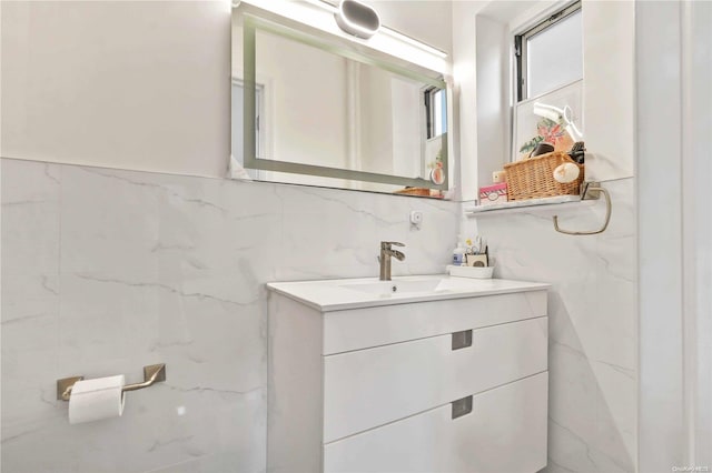 bathroom featuring vanity and tile walls