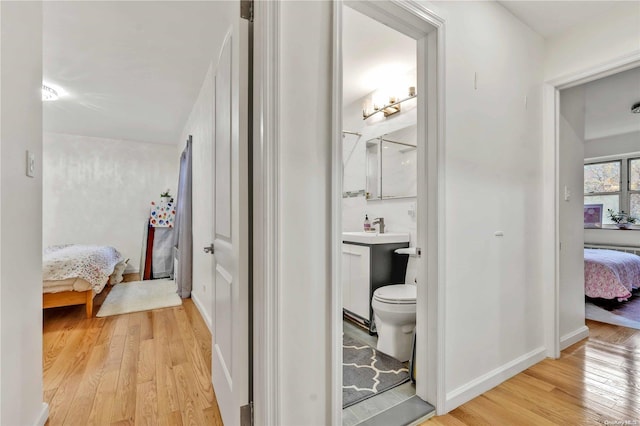 bathroom with hardwood / wood-style floors, vanity, and toilet