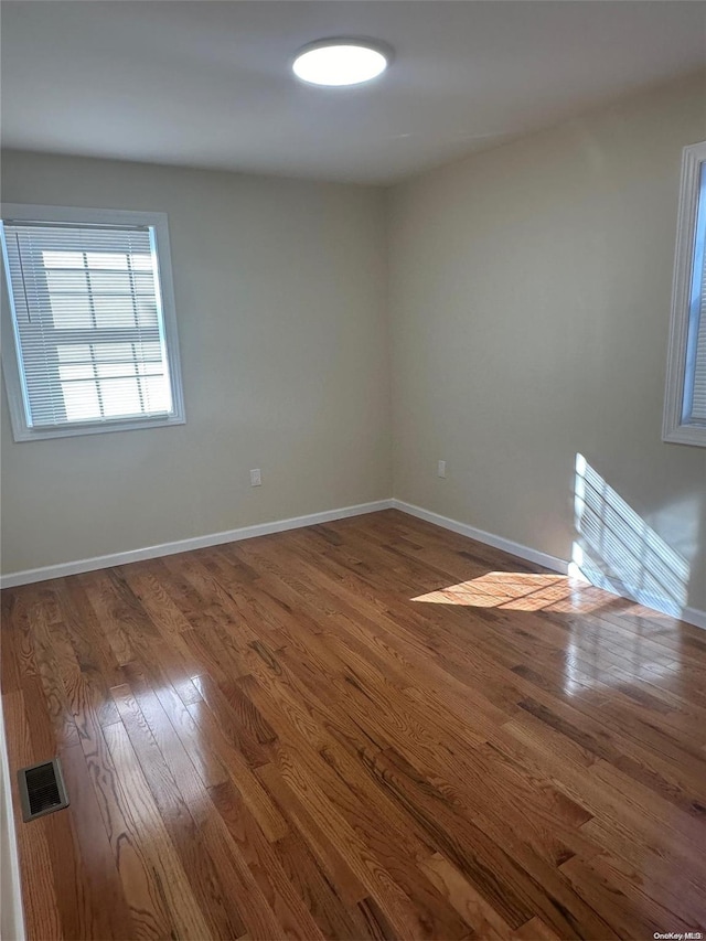 spare room with hardwood / wood-style flooring