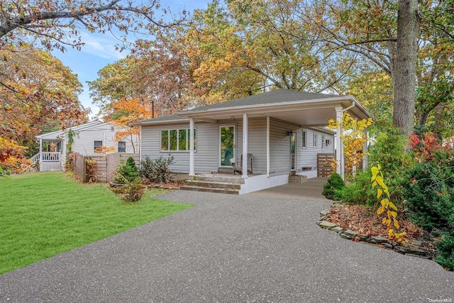 view of front facade with a front yard and a carport