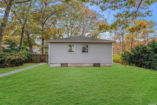 view of side of home with a yard