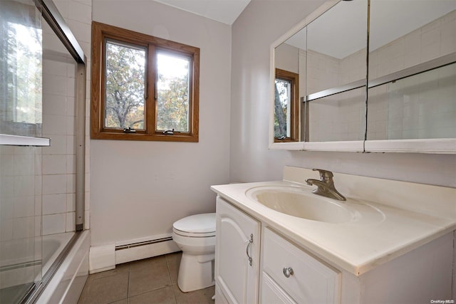 full bathroom featuring tile patterned floors, bath / shower combo with glass door, vanity, a baseboard heating unit, and toilet