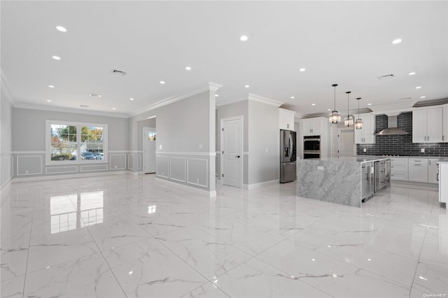 kitchen featuring white cabinets, stainless steel fridge, backsplash, and wall chimney range hood