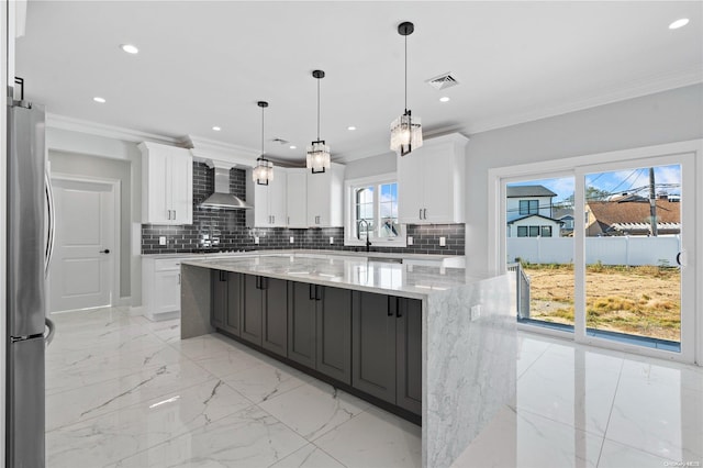 kitchen featuring a spacious island, white cabinetry, and stainless steel refrigerator