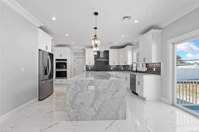 kitchen with backsplash, stainless steel appliances, pendant lighting, white cabinets, and a kitchen island