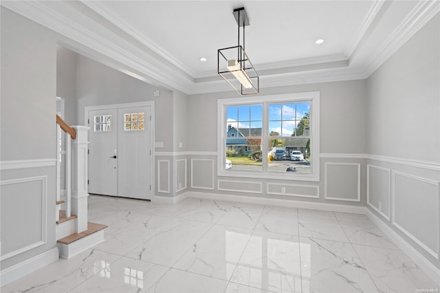 unfurnished dining area featuring ornamental molding and a tray ceiling