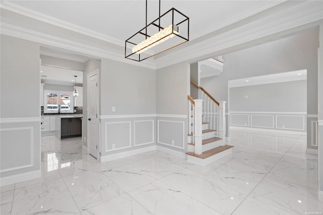 stairs with a chandelier and ornamental molding