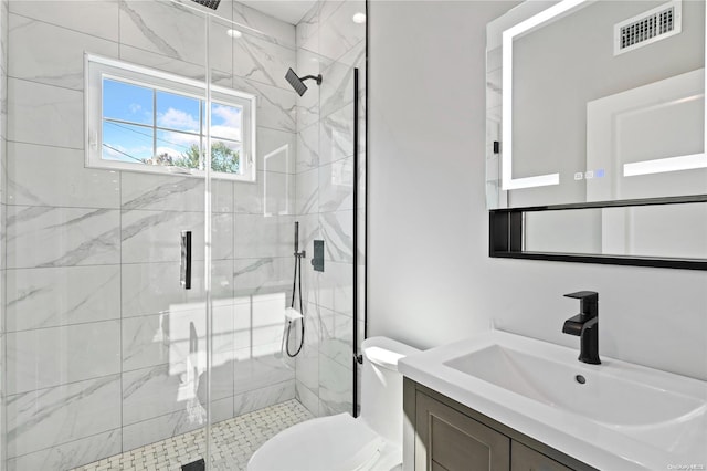 bathroom with a shower with door, vanity, and toilet