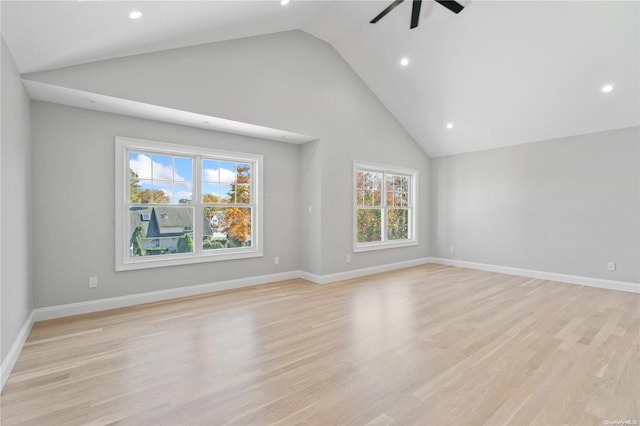 unfurnished living room with light hardwood / wood-style floors, high vaulted ceiling, and ceiling fan