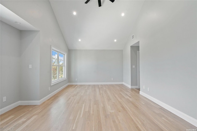 spare room featuring ceiling fan, light wood-type flooring, and high vaulted ceiling