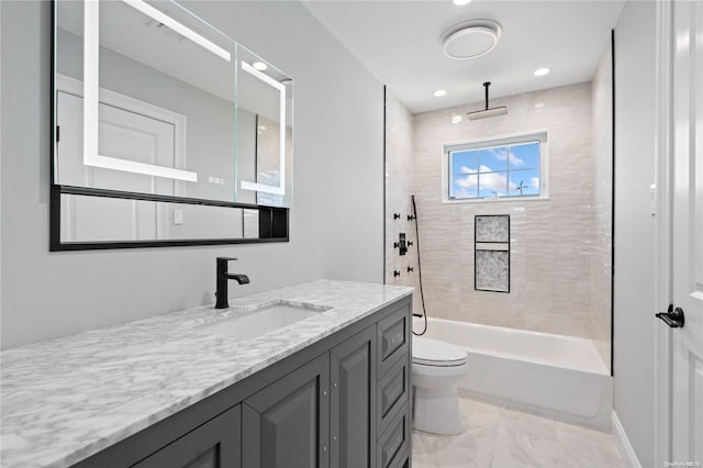 full bathroom with vanity, toilet, and tiled shower / bath combo