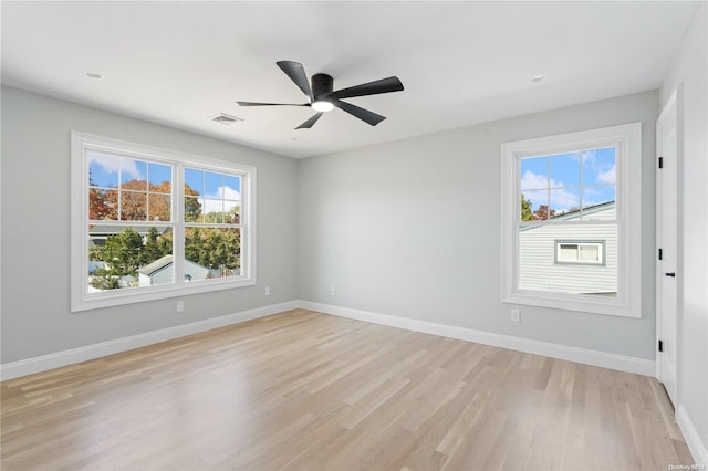 spare room featuring ceiling fan, plenty of natural light, and light hardwood / wood-style flooring