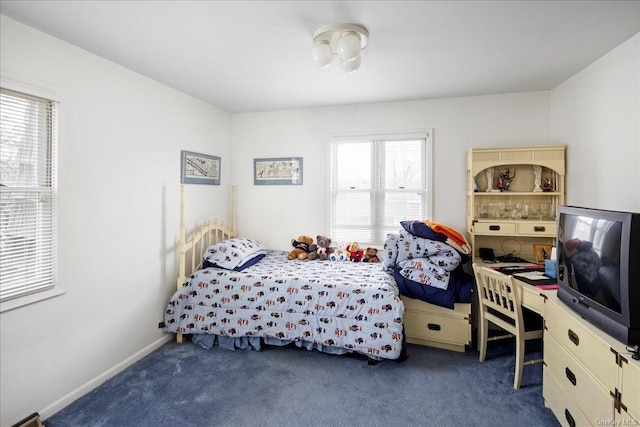 carpeted bedroom featuring multiple windows