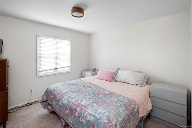 bedroom featuring light carpet