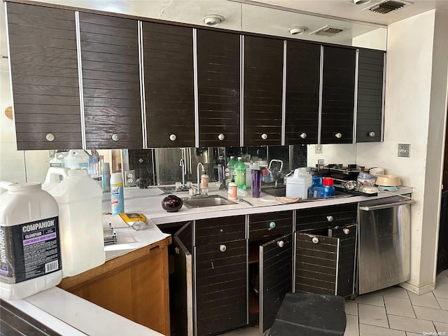 kitchen with sink, light tile patterned flooring, and dishwasher