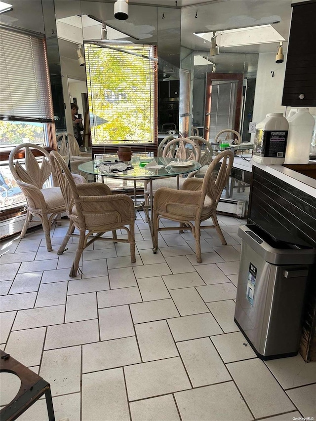 dining area featuring light tile patterned floors and a healthy amount of sunlight