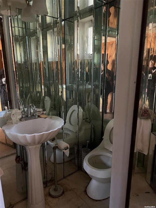 bathroom with toilet and tile patterned floors