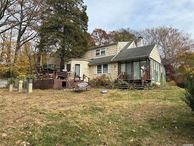 back of house with a yard and a wooden deck