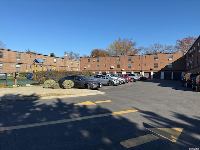 view of parking / parking lot featuring a playground