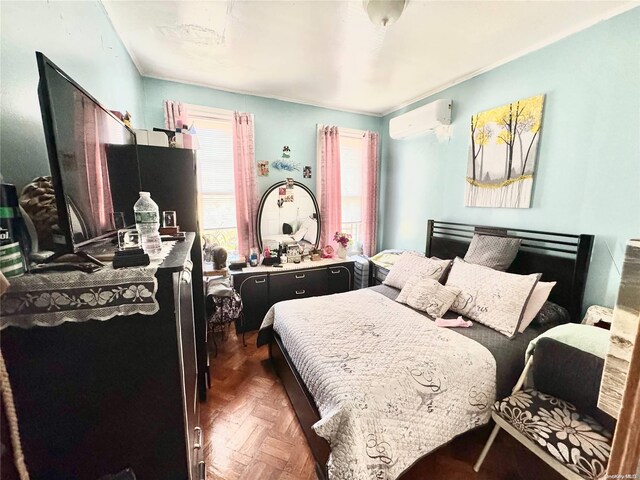 bedroom with an AC wall unit and dark parquet floors