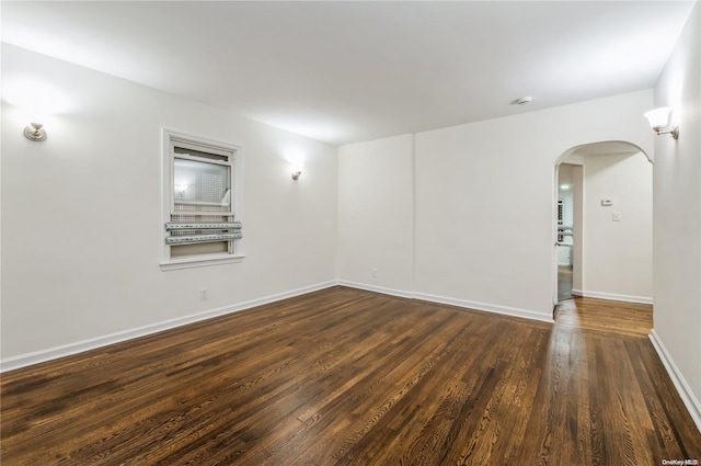 empty room with dark wood-type flooring