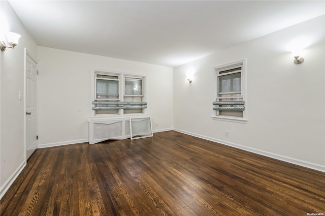 unfurnished living room with dark hardwood / wood-style floors