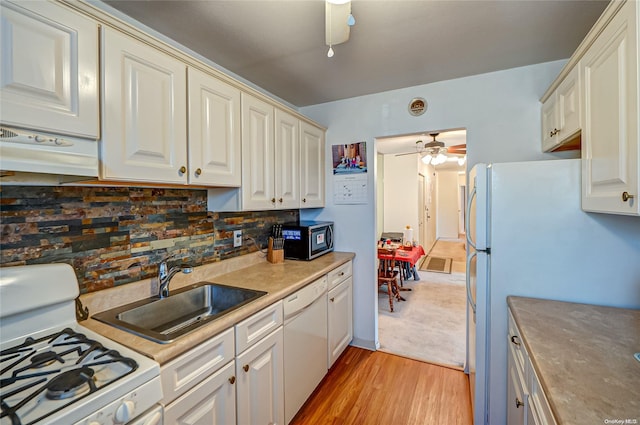 kitchen featuring decorative backsplash, white appliances, ceiling fan, sink, and light hardwood / wood-style flooring