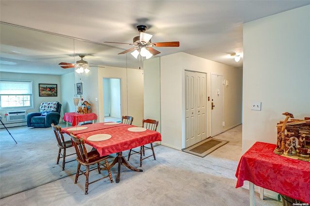 dining area with an AC wall unit, ceiling fan, and light colored carpet