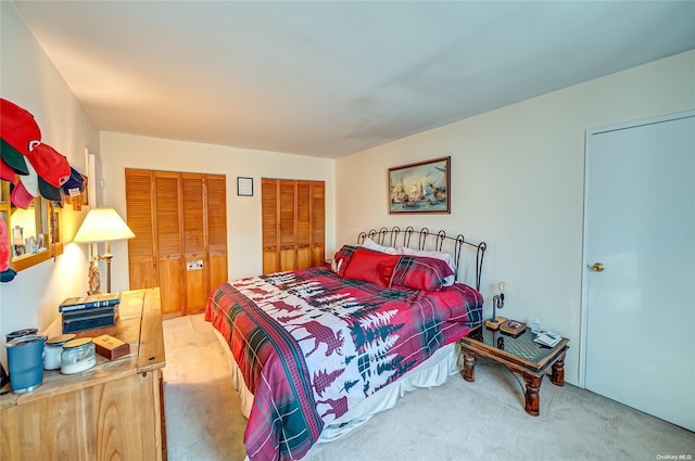 bedroom with carpet flooring and multiple closets