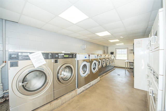 clothes washing area featuring washing machine and dryer and stacked washing maching and dryer