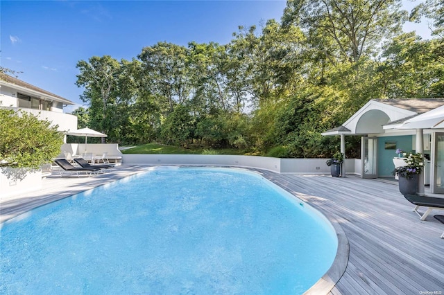 view of swimming pool with a patio area and a deck