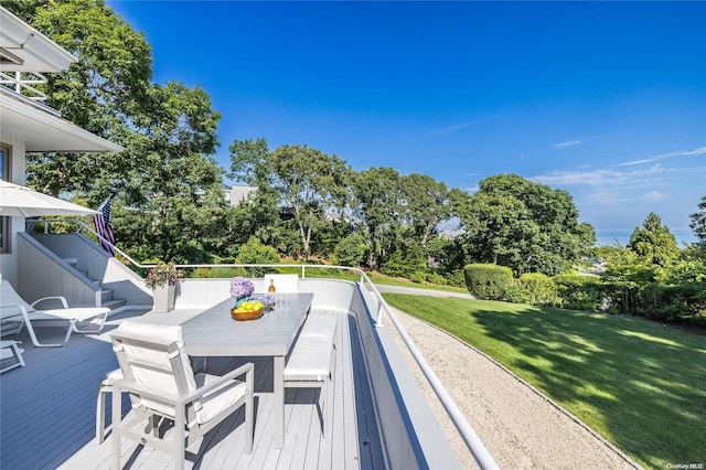 wooden terrace featuring a yard