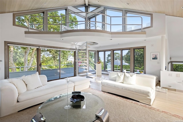 living room featuring high vaulted ceiling and wood ceiling